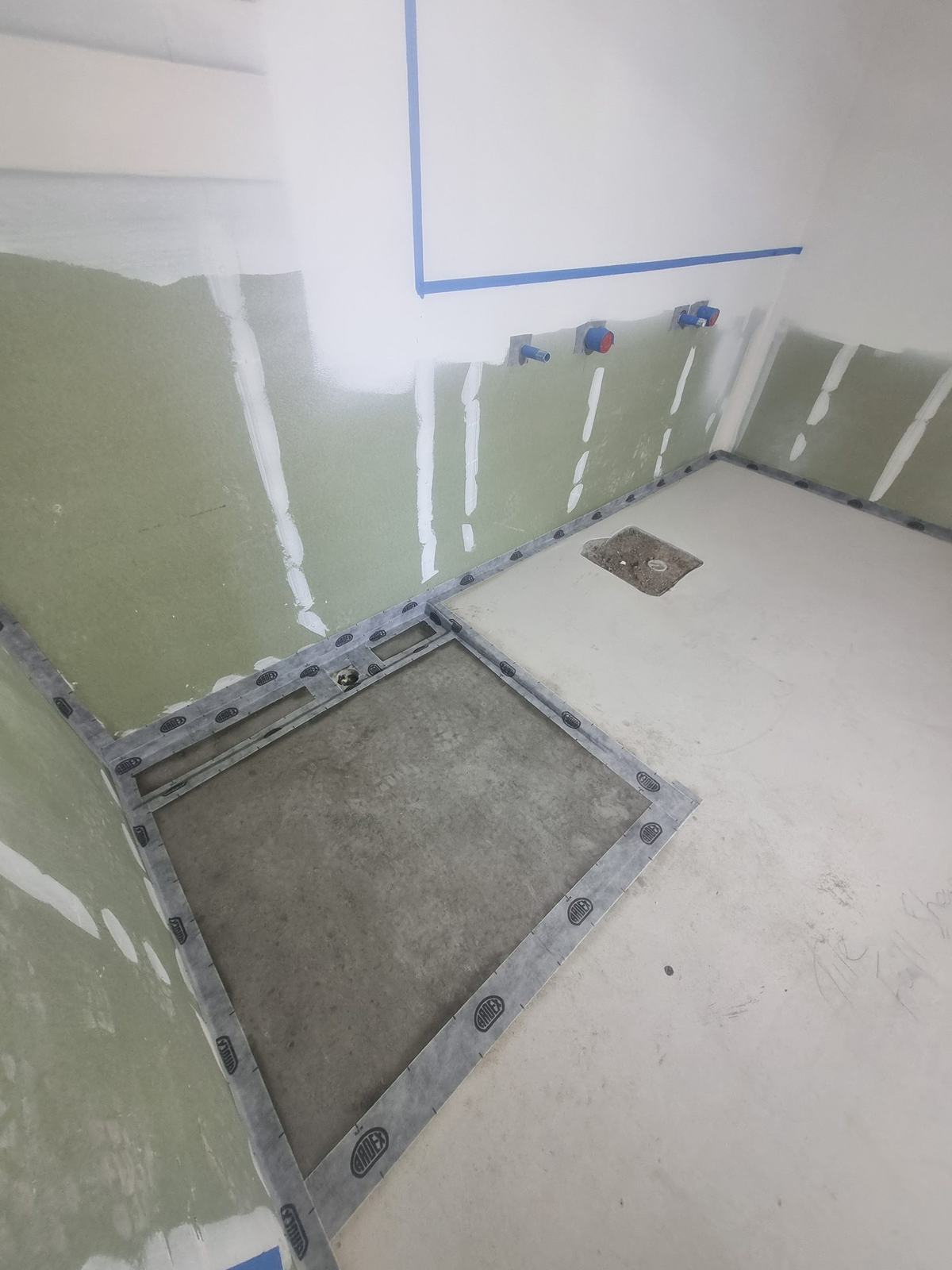 ARDEX sealing tape fitted around a shower tray and wall junctions before the waterproofing membrane