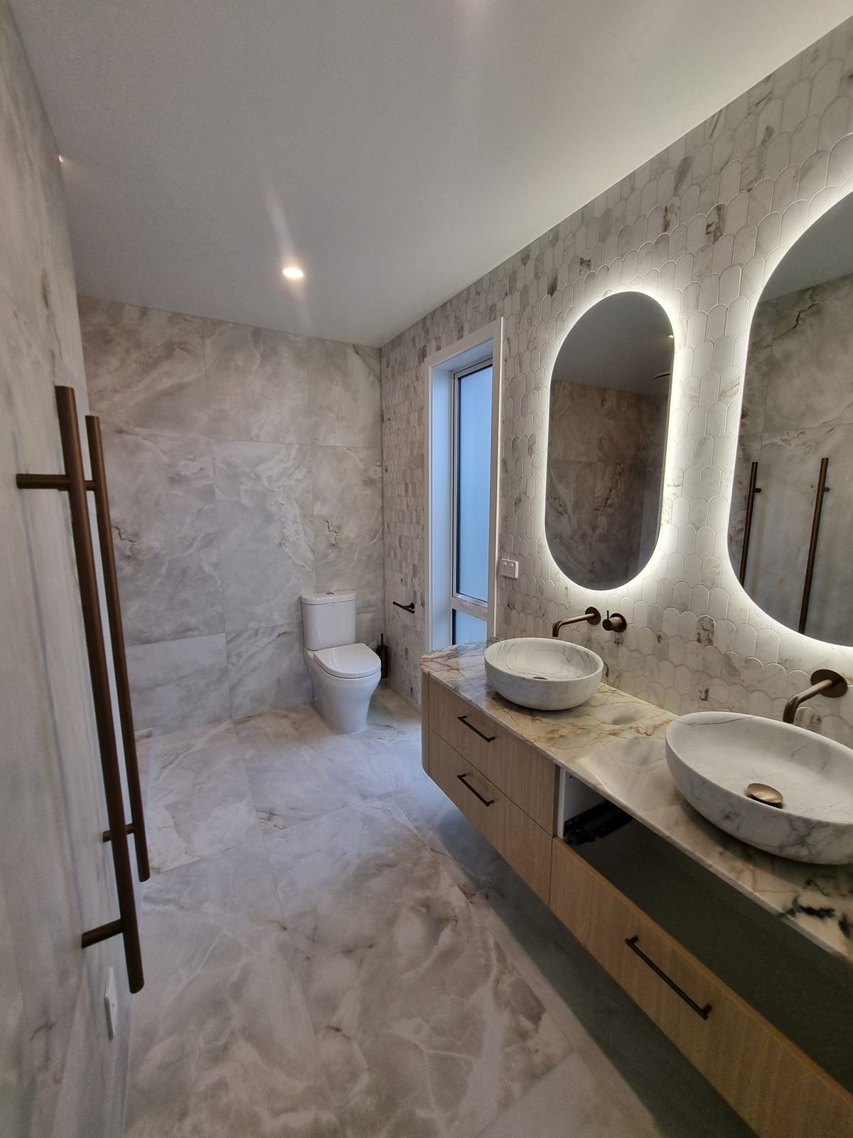 Porcelain and marble ensuite with a tiled walk-in shower, Taupō