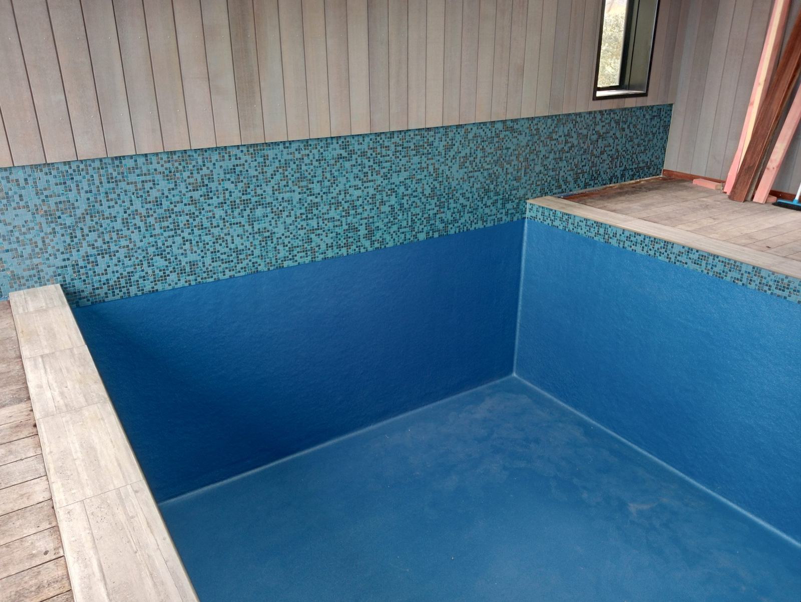 Indoor swimming pool lined with blue glass mosaic tile, Gisborne